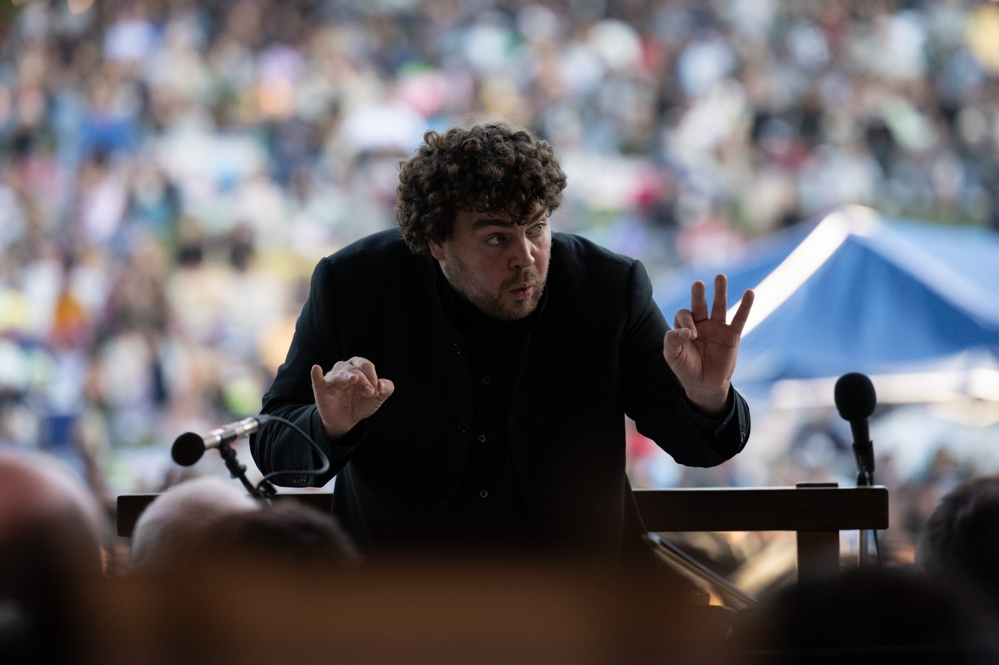 Finan Jones conducting an open-air concert in Atlanta.
